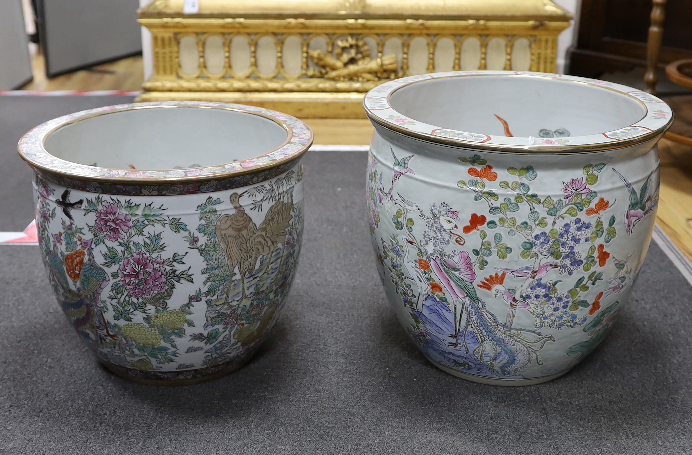 Two Chinese enamelled porcelain fish bowls, decorated with phoenixes and other birds, largest 42cm in diameter